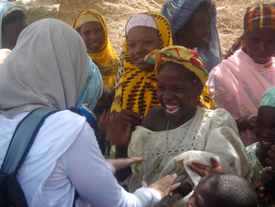 Aneesa teaches pat-a-cake to a young girl in Niger