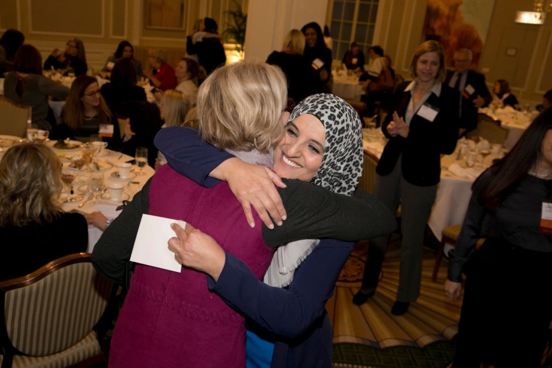 Aneesa hugs an attendee after speaking at the Professional Women's Club of Chicago (PWCC)